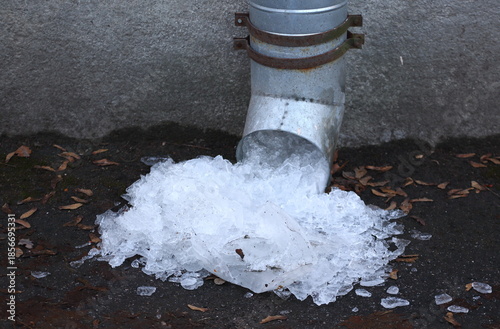 Melting ice that has fallen out of a drainpipe
