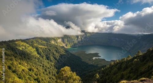 Panoramic view of a volcanic crater lake nestled in lush green mountains under a partly cloudy sky