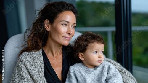 A heartwarming portrayal of a mother and her toddler, captured in a cozy setting that evokes warmth, love, and the special bond between parent and child.