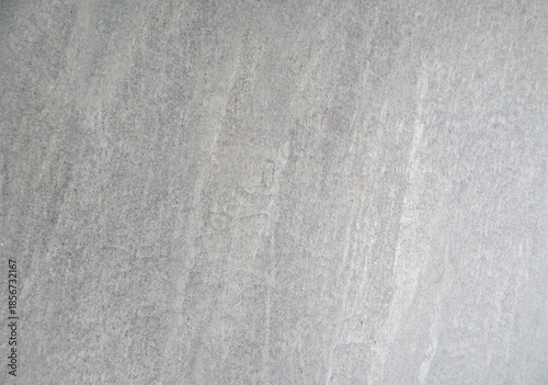 Neutral gray textured surface with subtle concrete or plaster patterns