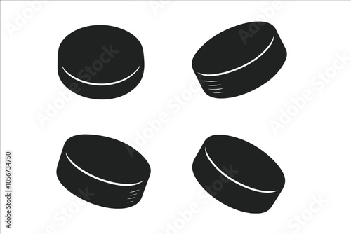 Four Dark Hockey Pucks on a Dark Background