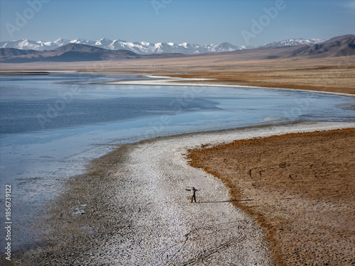 a tourist on the shore of a salt lake