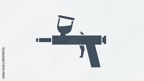 A dark gray paintball gun is centered on a white background viewed directly from the side