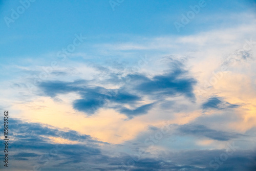 Fotografia Dramatic blue sky with golden clouds at sunset with soft color transitions and a