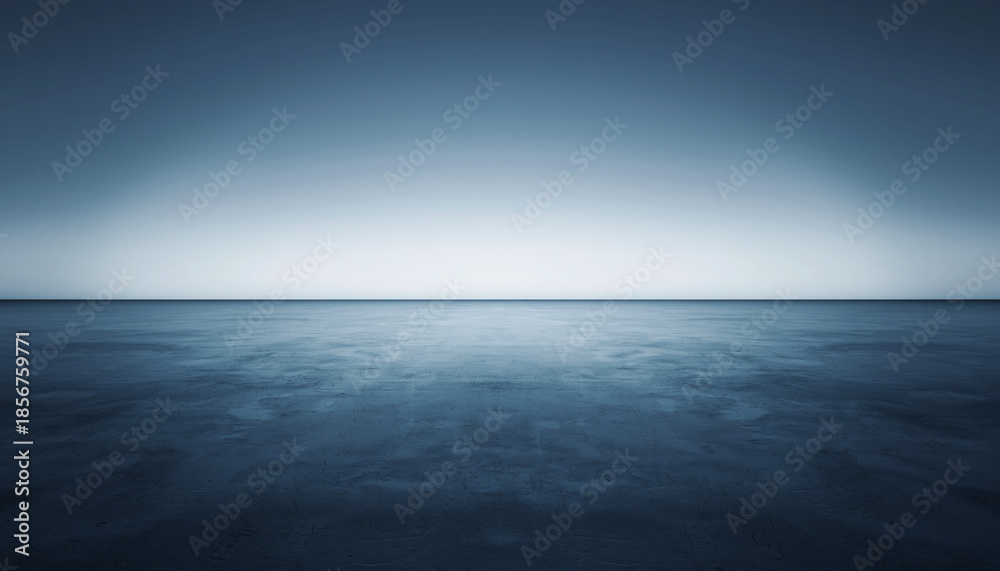 Fototapeta premium Calm ocean waters under a serene blue gradient sky