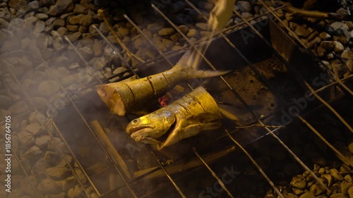 The traditional process of grilling fish at night.