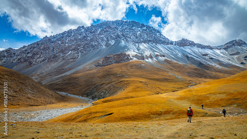 Tian Shan mountains glacier and snow summits on a sunny day with blue sky. Kyrgyzstan mountains on the border with China high altitude snow and glacier trek, climbing and alpinism in the wilderness