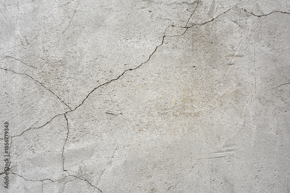 Fototapeta premium clay wall. the old clay wall is crumbling. surface wall for vintage background. Wall texture for background. old cracked plaster, grey cement floor, needs repair, restoration