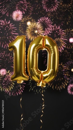 Gold balloon number 10 with fireworks in the background. Festive scene for birthday or anniversary party