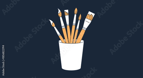 Set of professional artist paintbrushes standing in a simple white cup against a dark navy background for a creative studio look.
