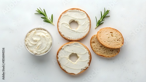 Top View of Cream Cheese Bagel Halves with Rosemary Sprigs and Whipped Cream Cheese in a Small Dish
