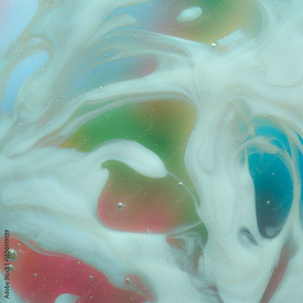 Obraz premium Macro abstract image of smooth white milky liquid with soft green, red, blue and yellow patches, gentle flowing shapes and subtle bubbles, dreamy pastel fluid texture filling the frame
