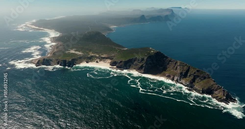 Wide aerial drone view of the Cape of Good Hope in South Africa Coastal cliffs, turquoise water, sandy beach, and green terrain on a sunny day. Perfect for travel, nature, and documentary footage.