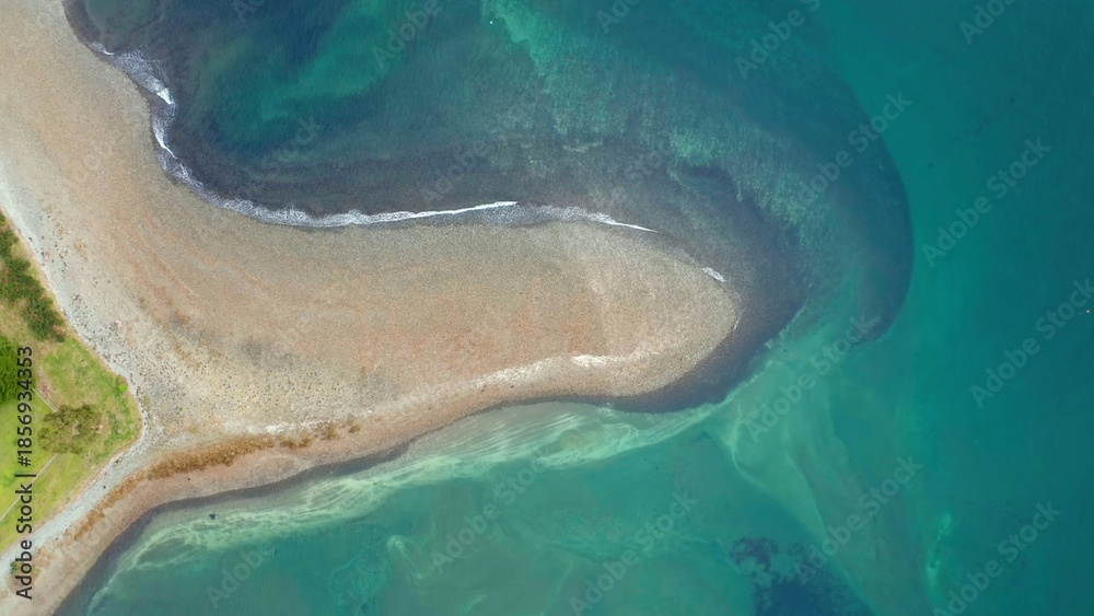 Fototapeta premium Aerial view of sandy shoreline and turquoise sea 