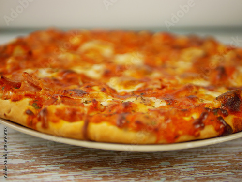 Wallpaper Mural Fresh Pizza on Plate with Shallow Depth of Field Highlighting Toppings Crust Texture and Cozy Dining Atmosphere Torontodigital.ca