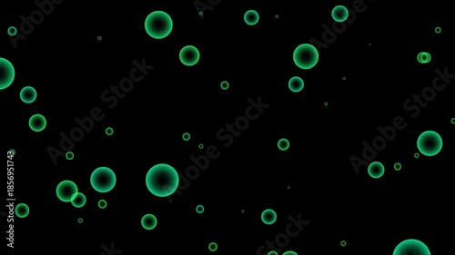 A dark background with numerous varying sizes of bright green circular shapes dispersed throughout the frame