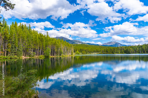 Obraz na plátně Herbert lake reflecting clouds and mountains in banff national park