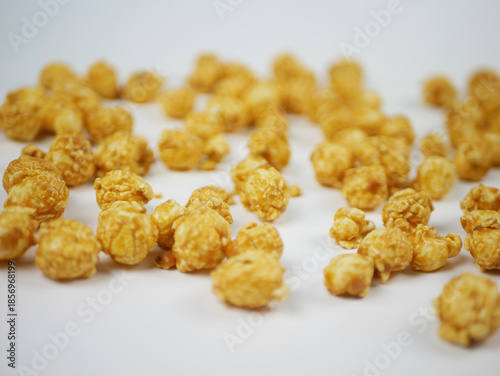 Wallpaper Mural Side view of a pile of caramel popcorn balls on white table with soft blur, sweet crunchy snack concept for cinema food, branding and clean background Torontodigital.ca