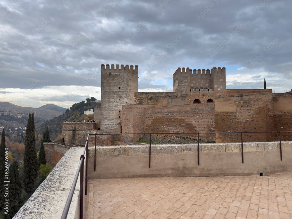 Obraz premium Historic Fortress with Towers Against a Cloudy Sky