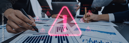 Cuadro en lienzo Business professionals engage in a collaborative analysis of various reports, highlighting critical warnings and alerts in a modern office setting to ensure informed decision-making