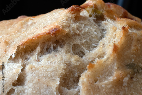 close up of a sourdough bread with cheese and olives