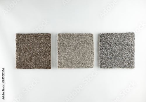 difficult choice concept illustration - similar grey carpet samples on white background 
