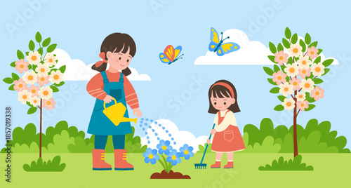 Two little sisters planting flowers together in the garden. Two little girls working together outside in the garden.