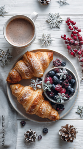 Croissant breakfast with berries and hot coffee on winter table