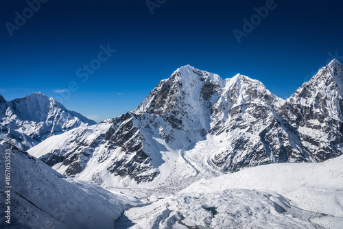Helicopter flight over the huge Khumbu valley with Tabuche and Cholatse peaks on the horizon. Everest base camp trek, Himalaya mountains, Nepal.