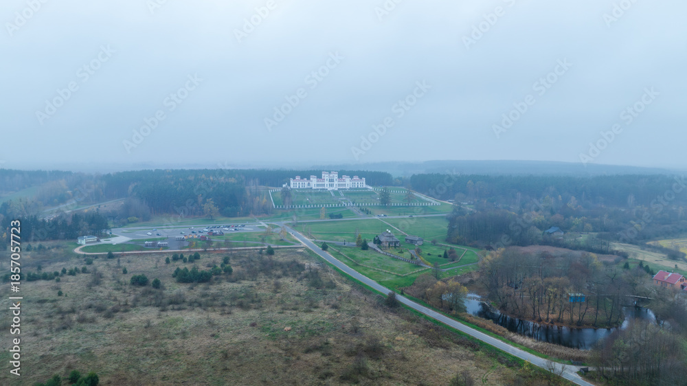 Fototapeta premium Aerial Belarus manor with white neo Gothic palace and river bend