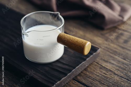 Canvas Print Milk in measuring glass cup