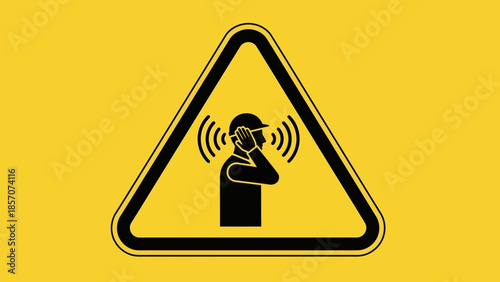 Warning sign depicting a person in a hard hat falling down a flight of stairs, indicating a trip hazard on a yellow background.