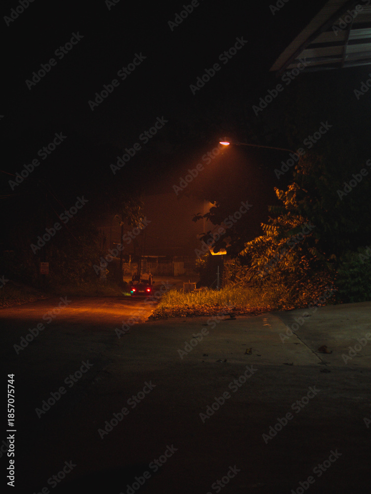Fototapeta premium Empty Night Road With Warm Street Light Glow