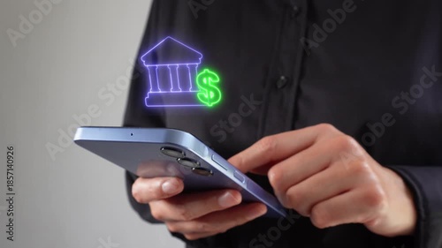 Banking and finance. Executive interacting with her cell phone screen with a virtual bank icon and a money symbol.