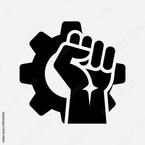 Black silhouette of a raised clenched fist in front of a gear, symbolizing labor, industry, and power.