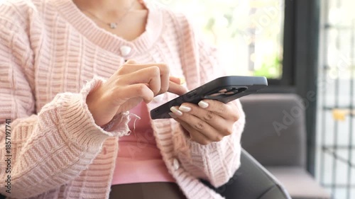 A young woman works on a laptop while sitting in a modern café, enjoying a quiet moment with coffee, reflecting a freelance lifestyle, remote work, and productivity in a cozy space.