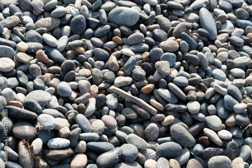 Nestled by the soothing waves, a luxurious spa invites travelers to indulge in relaxation amid smooth, colorful pebbles and breathtaking sea views, creating a perfect getaway.