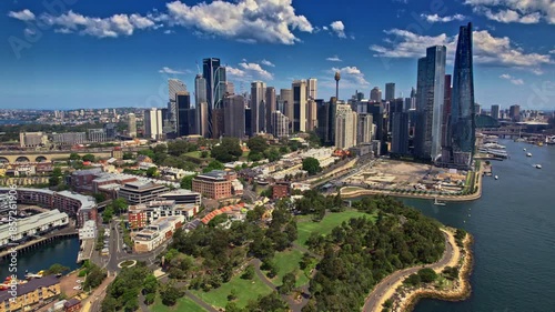 Cityscape With Water, Modern City Skyline Reflecting Sunlight Beside Bustling Harbor And Park