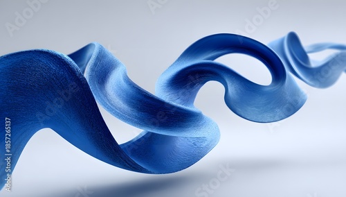 Abstract flowing ribbon of deep blue textured material with subtle light reflections creating a sense of movement and depth on a soft gray background