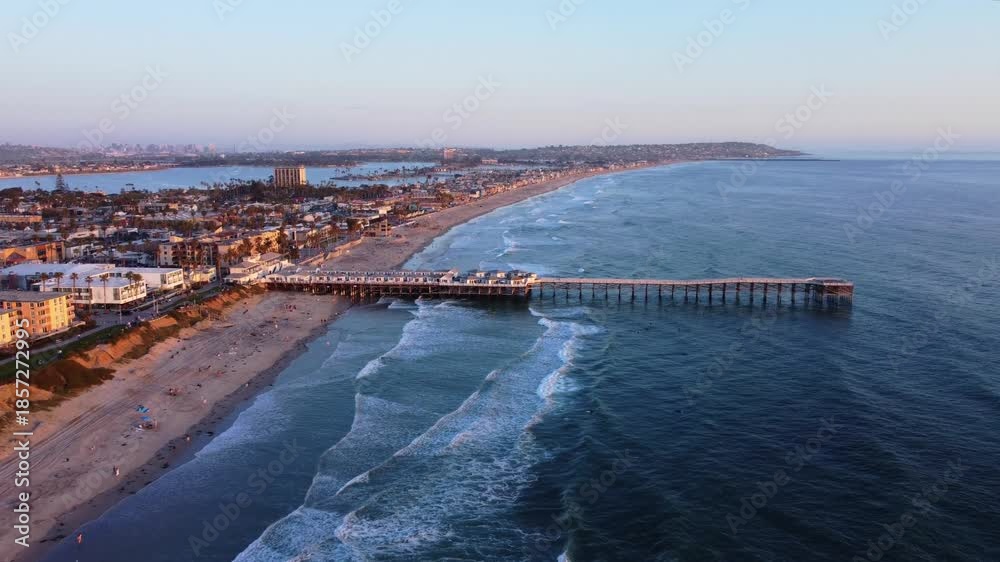 custom made wallpaper toronto digitalPacific Beach Sunset at Pier, looking towards San Diego skyline, Southern California. Aerial drone view of sandy shores, beachfront buildings, bike path, and pier on a nice warm summer evening.