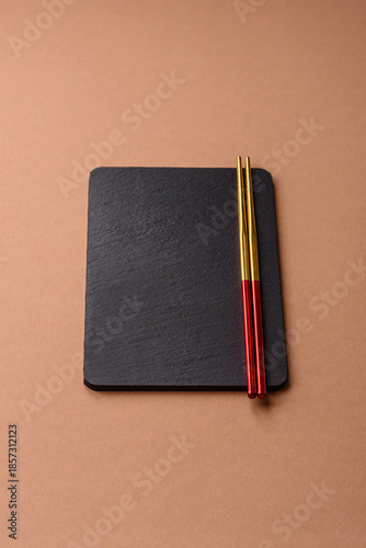 A black slate stone board or plate, an empty kitchen utensil. A black slate board