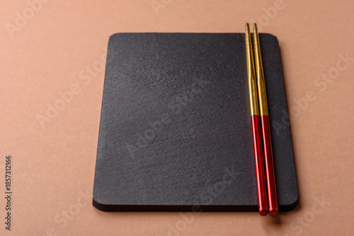 A black slate stone board or plate, an empty kitchen utensil. A black slate board