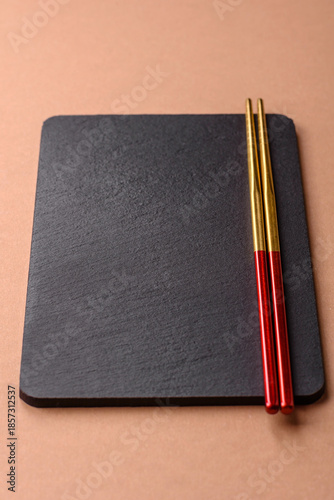 A black slate stone board or plate, an empty kitchen utensil. A black slate board