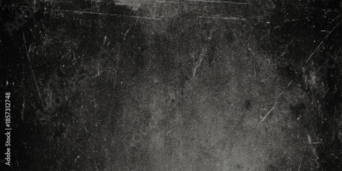 A heavily scratched and distressed black surface texture showing significant wear and tear with a grainy appearance