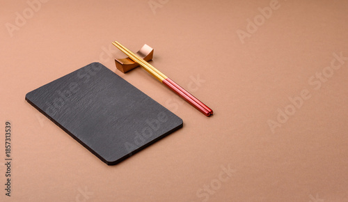 A black slate stone board or plate, an empty kitchen utensil. A black slate board