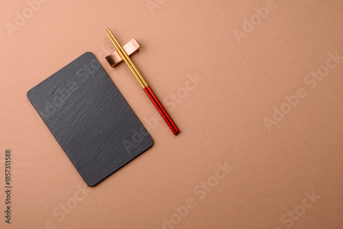 A black slate stone board or plate, an empty kitchen utensil. A black slate board