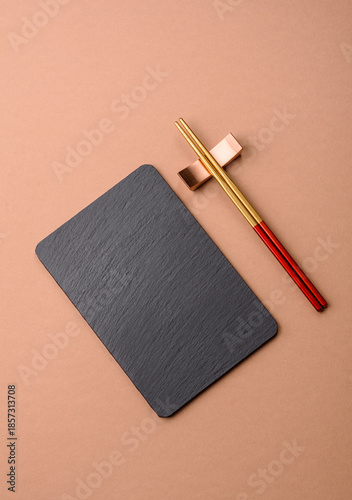 A black slate stone board or plate, an empty kitchen utensil. A black slate board