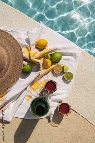 citrus and drinks next to pool on sunny day