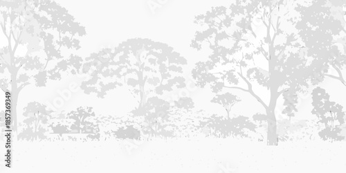 Silhouetted trees and grassland landscape at dusk or dawn soft lighting