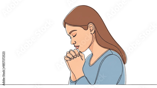 A serene young woman praying with eyes closed in contemplation